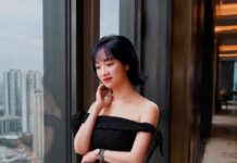 Làm người tình hay làm vợ: Cái sướng ngắn và cái giá dài Làm người tình hay làm vợ - người phụ nữ mặc váy đen bên cửa kính